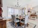 Spacious dining area with a large table and elegant chandelier at 933 El Lago Ter, Winter Springs, FL 32708