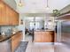 Open kitchen with stainless steel appliances and view into dining area at 933 El Lago Ter, Winter Springs, FL 32708