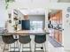Kitchen island with seating, wood cabinets, and stainless steel appliances at 933 El Lago Ter, Winter Springs, FL 32708
