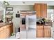 Stainless steel refrigerator in kitchen with wood cabinets and countertops at 933 El Lago Ter, Winter Springs, FL 32708