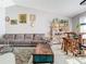 Sunlit living room with a brown couch and wooden coffee table at 933 El Lago Ter, Winter Springs, FL 32708