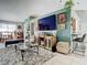Open concept living room with large TV and kitchen peek at 933 El Lago Ter, Winter Springs, FL 32708