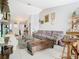 Living room showcasing a brown couch, coffee table, and eclectic decor at 933 El Lago Ter, Winter Springs, FL 32708