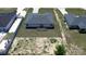 Aerial view of the backyard featuring a pergola covered patio with a sandy area at 105 Marion Oaks Manor, Ocala, FL 34473