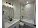 Modern bathroom featuring marble-look tile surround and matte black fixtures at 105 Marion Oaks Manor, Ocala, FL 34473