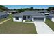 A charming single-story home boasts a well-manicured lawn and a welcoming, modern facade at 105 Marion Oaks Manor, Ocala, FL 34473