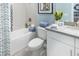 Clean bathroom with a tub, toilet and modern vanity at 1212 Teal Creek Dr, St Cloud, FL 34769