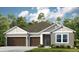 Two-story house with brown double doors and attached garage at 1212 Teal Creek Dr, St Cloud, FL 34769