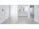 Bright entryway with modern gray tile floor and white cabinets at 12162 Graduate Dr, Orlando, FL 32826