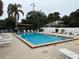 Community pool with lounge chairs and shaded seating area at 12162 Graduate Dr, Orlando, FL 32826