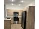 Modern kitchen with stainless steel appliances and light wood cabinets at 1230 Southstation Pl # 105, Orlando, FL 32809