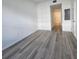 Spacious bedroom with wood-look flooring and access to the bathroom at 1230 Southstation Pl # 105, Orlando, FL 32809
