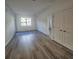 Bright and airy living room with wood-look floors and large windows at 1230 Southstation Pl # 105, Orlando, FL 32809