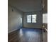 Living room with large windows and access to a private patio at 1230 Southstation Pl # 105, Orlando, FL 32809