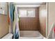 Clean bathroom with a tub and shower, tiled walls, and a colorful shower curtain at 1309 Paradise Ln, Winter Park, FL 32792