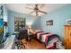 Bright bedroom with a twin bed, desk, chair, and ceiling fan at 1309 Paradise Ln, Winter Park, FL 32792