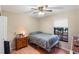 Cozy bedroom with a twin bed, dresser, and ceiling fan at 1309 Paradise Ln, Winter Park, FL 32792