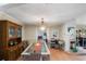 Dining room with glass-top table, wood hutch, and view to living area at 1309 Paradise Ln, Winter Park, FL 32792