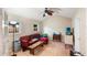 Cozy Gathering room features a red sectional sofa and a ceiling fan at 1309 Paradise Ln, Winter Park, FL 32792