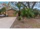 Tan house with attached garage and palm trees at 1309 Paradise Ln, Winter Park, FL 32792