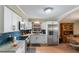 Modern kitchen with stainless steel appliances and granite countertops at 1309 Paradise Ln, Winter Park, FL 32792