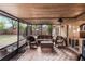 Cozy screened porch with wicker furniture and backyard access at 1309 Paradise Ln, Winter Park, FL 32792