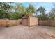 Detached storage shed with a garage door in the backyard at 1309 Paradise Ln, Winter Park, FL 32792