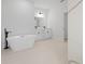 Main bathroom with freestanding tub, double vanity, and marble tile at 15410 Sw 23Rd Court R, Ocala, FL 34473