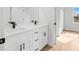Double vanity bathroom with white cabinets and black accents at 15410 Sw 23Rd Court R, Ocala, FL 34473