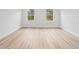 Spacious bedroom with two windows and light wood flooring at 15410 Sw 23Rd Court R, Ocala, FL 34473