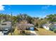 Aerial view of a single-Gathering home with a yard and driveway, next to other homes at 1734 Weltin St, Orlando, FL 32803