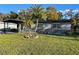 Front view of ranch home with palm trees and well-manicured lawn at 1801 Hage Way, Orlando, FL 32805