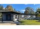 Ranch-style home with gray exterior, landscaping, and a carport at 1801 Hage Way, Orlando, FL 32805