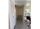 Hallway with gray wood floors, white walls, and entrance to carpeted living room at 1801 Hage Way, Orlando, FL 32805