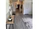 Hallway with gray wood floors, white walls, and visible dining and kitchen areas at 1801 Hage Way, Orlando, FL 32805