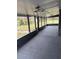 Spacious screened porch with grey carpeting and modern light fixture at 1801 Hage Way, Orlando, FL 32805