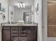 Double vanity bathroom with granite countertop and walk-in shower at 1913 Nice Ct, Kissimmee, FL 34747