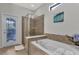 Bathroom with a shower, garden access, and soaking tub at 1913 Nice Ct, Kissimmee, FL 34747