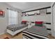 Bedroom with twin beds, black and white decor, and wall shelving at 1913 Nice Ct, Kissimmee, FL 34747