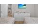 Bedroom with twin beds, dresser, and view of living area at 1913 Nice Ct, Kissimmee, FL 34747