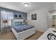 Bright bedroom with king-size bed and access to another room at 1913 Nice Ct, Kissimmee, FL 34747