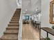 Bright entryway with staircase, tile flooring, and views into the living and kitchen areas at 1913 Nice Ct, Kissimmee, FL 34747