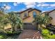 Two-story house with a brown garage door and brick driveway at 1913 Nice Ct, Kissimmee, FL 34747