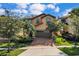 Two-story house with a brown garage door and brick driveway at 1913 Nice Ct, Kissimmee, FL 34747