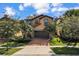 Two-story house with a brown garage door and brick driveway at 1913 Nice Ct, Kissimmee, FL 34747