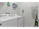 Bright laundry room with Whirlpool washer and dryer, and ample shelving at 1913 Nice Ct, Kissimmee, FL 34747