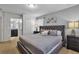 Main bedroom with king-size bed, ensuite bathroom access, and gray decor at 1913 Nice Ct, Kissimmee, FL 34747