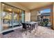 Covered patio with seating area and glass sliding doors leading to the pool at 1913 Nice Ct, Kissimmee, FL 34747