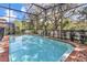 Inviting rectangular swimming pool with brick deck and screened enclosure at 1913 Nice Ct, Kissimmee, FL 34747
