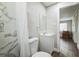 Clean bathroom with marble-look shower, vanity, and toilet at 1913 Nw 12Th St, Ocala, FL 34475